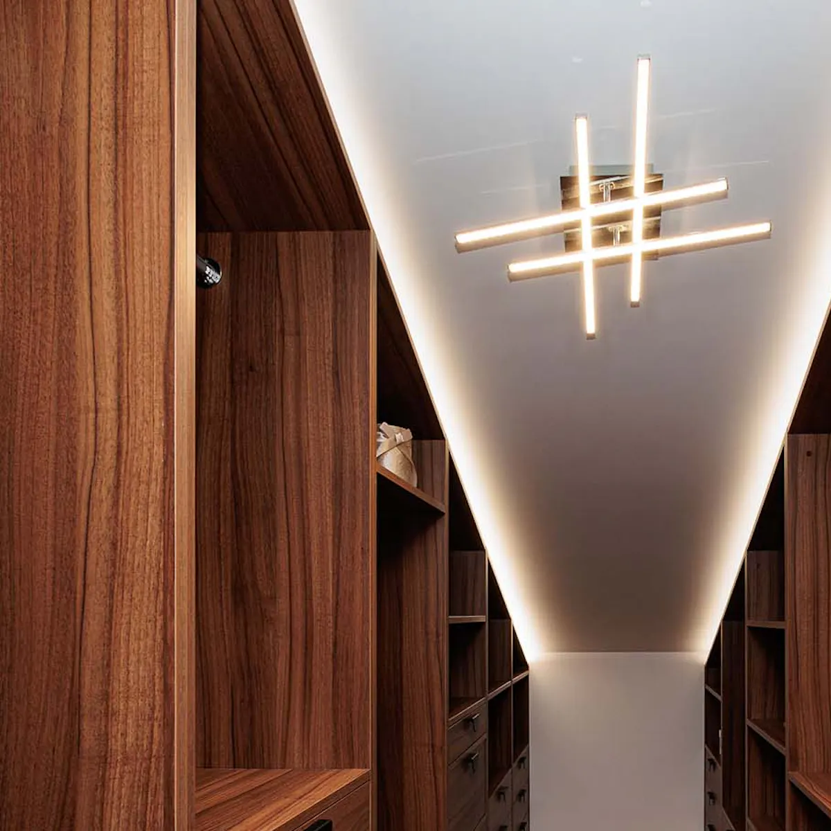 Dark brown built-in closet in a room with sloped ceilings