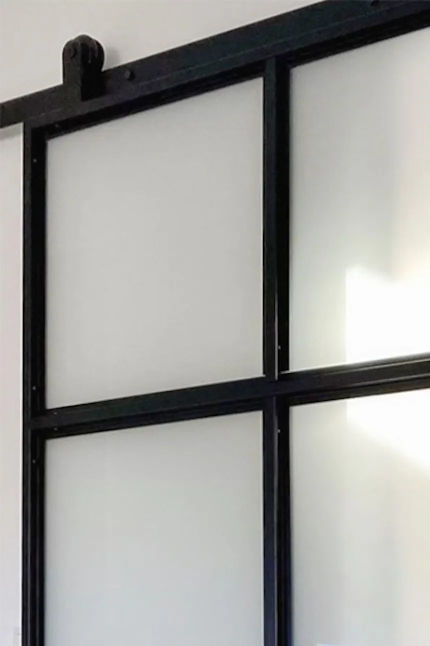 Loft sliding glass doors to a dressing room with white furniture