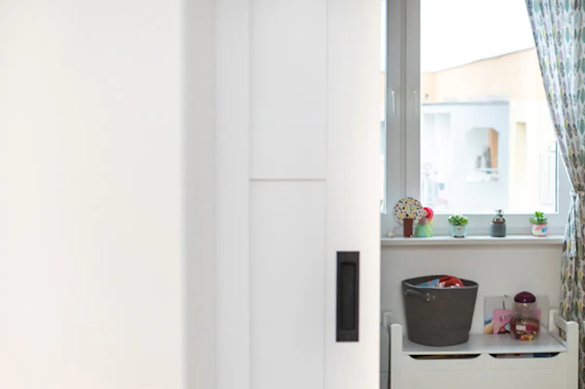 Sliding door in apartment, wooden sliding door, white sliding door, elegant sliding door, sliding door in kids' room, space-saving sliding door, wood toy storage