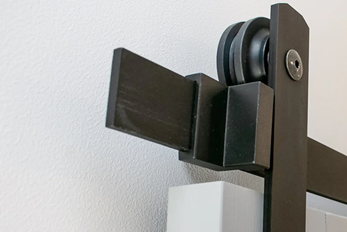 Black sliding system for grey wood doors.