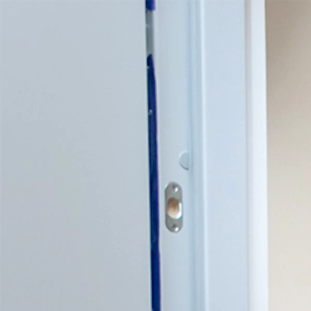 Grey sliding door for laundry room in small apartment.