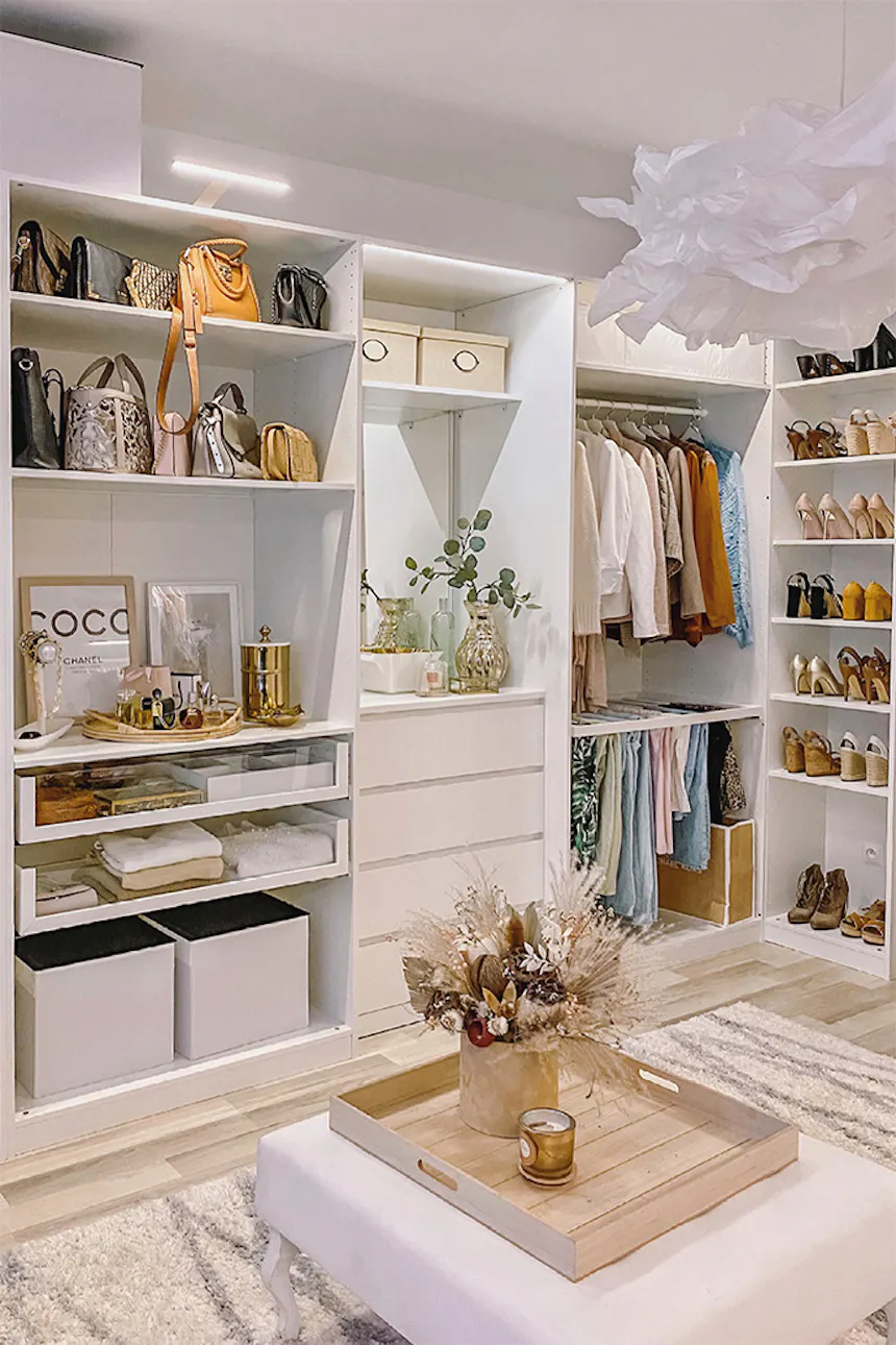 system of white shelves in the dressing room, large bright dressing room, white shelves, white pouf in the walk-in closet