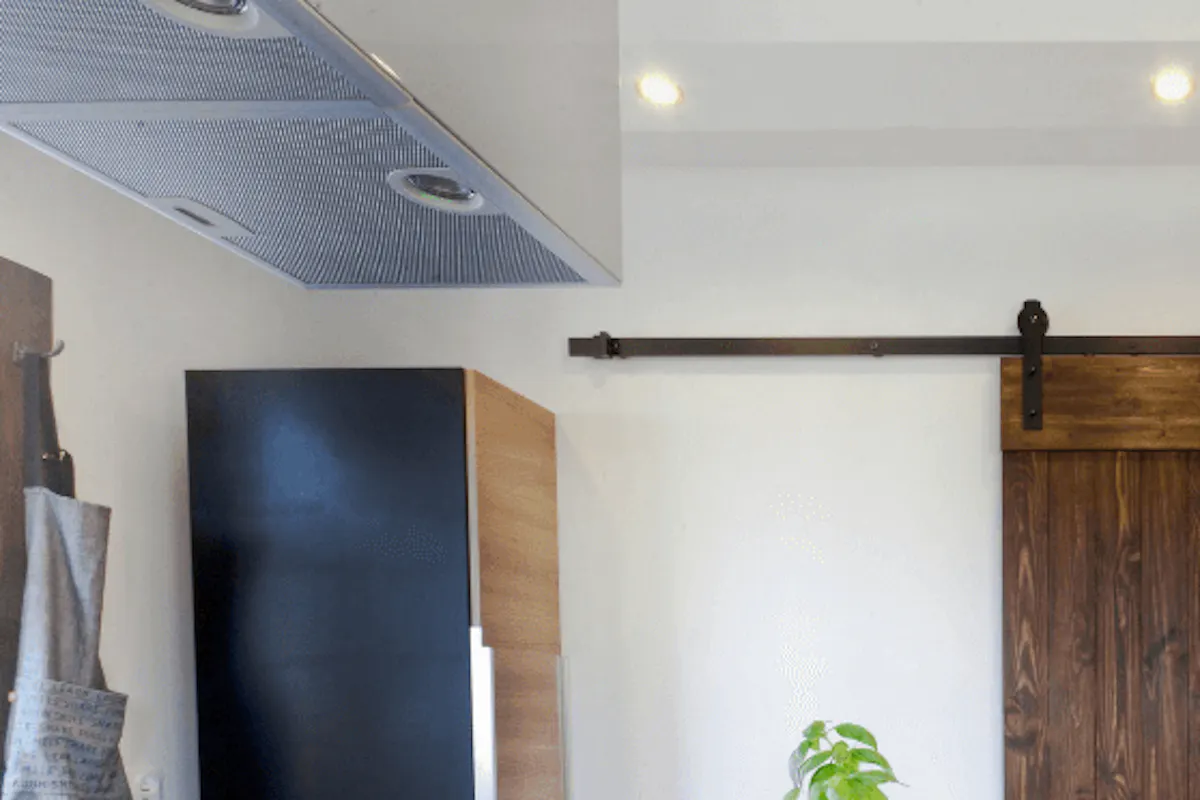 Sliding doors to pantry in a spacious kitchen