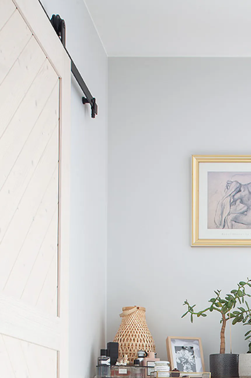 cream chest of drawers with decorative stucco in a bright bedroom