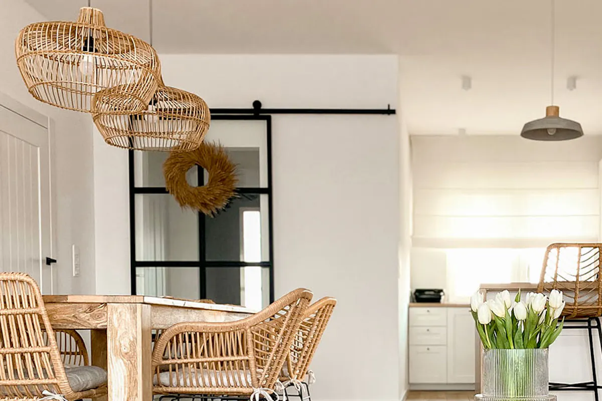 Living room with white walls and natural wood, rattan, and woven furniture