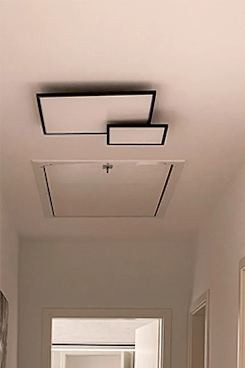 Corridor with white walls, metal accessories and minimalist wall décor.