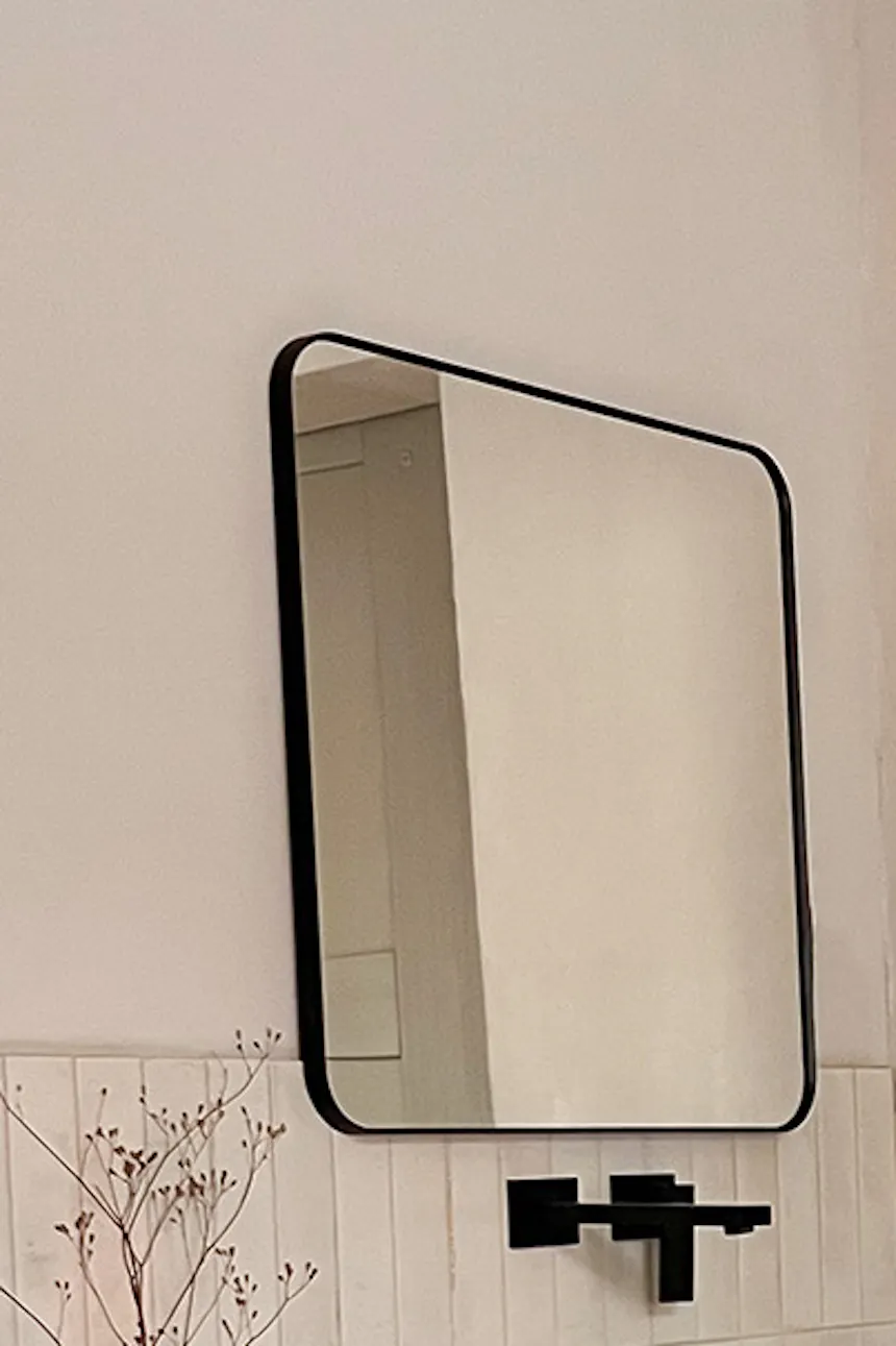 Square mirror above rectangular sink on white cabinet with large drawers