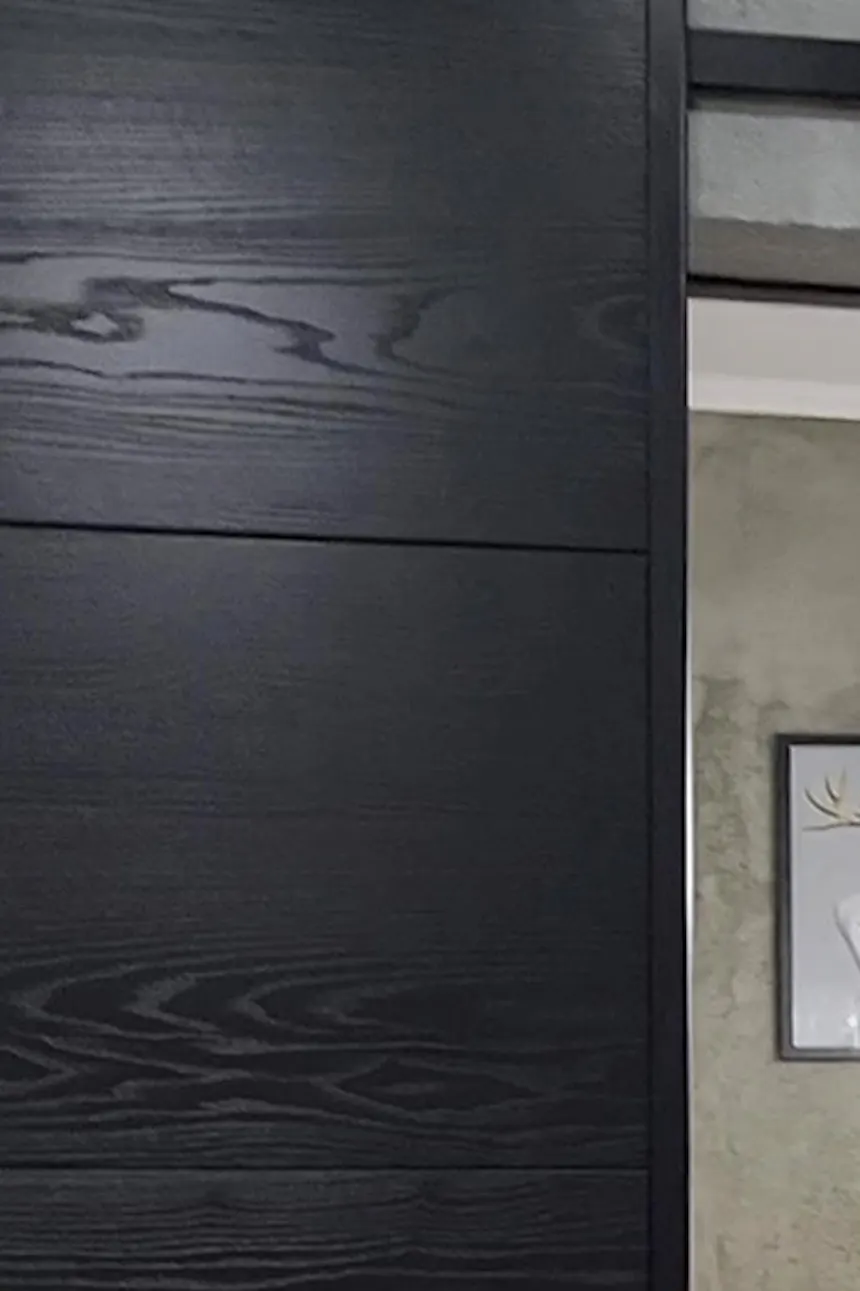 ajar sliding door showing the interior of a white and gray bathroom