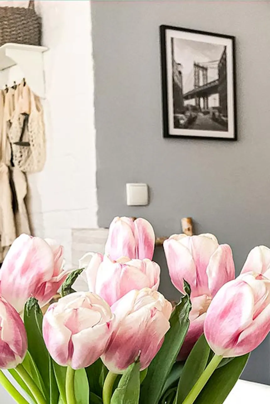 sliding doors in a small apartment, tulips on a white dining table in a small living room, sliding door in a small apartment, white dining table and chairs