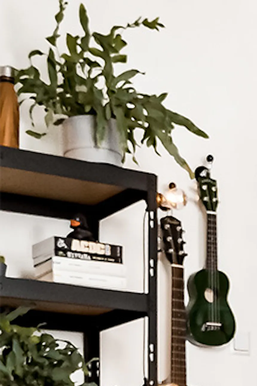 Student room setup, metal accessories, loft-style décor, sliding door, metal plant stand, wood floor and glass door