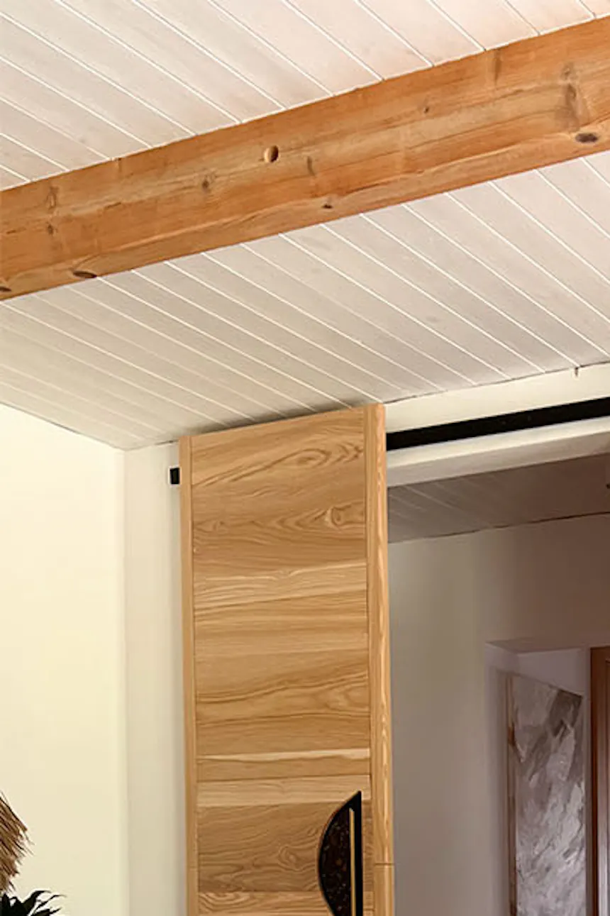 designer wooden sliding doors with black handles in the arrangement of the living room