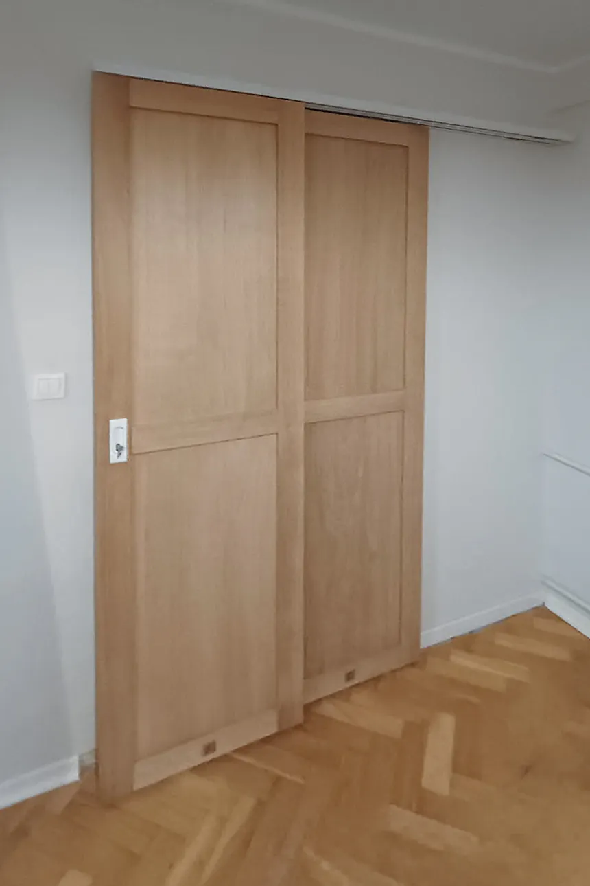 Bypass sliding system with narrow door panels on parallel tracks for easy opening and closing