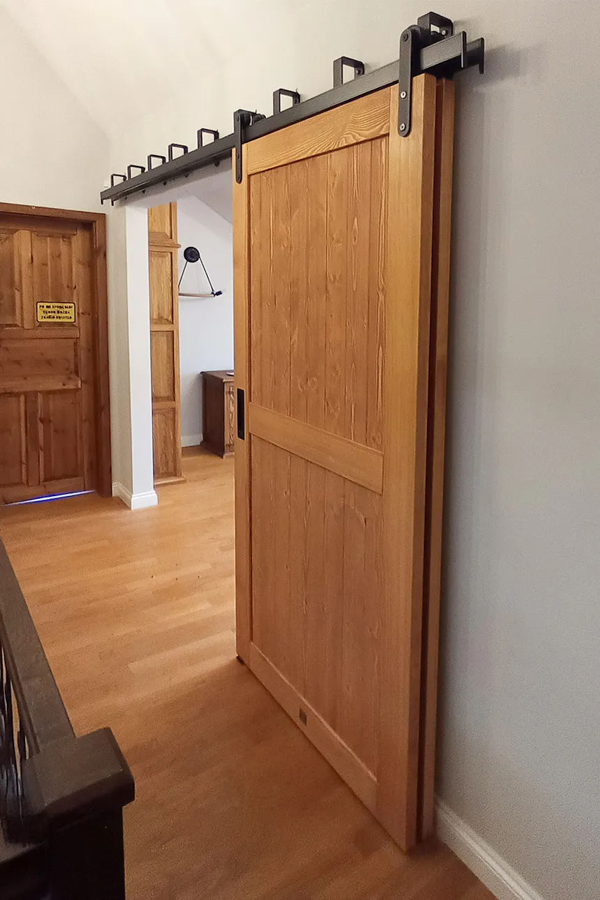 Bypass sliding doors fully open with wood panels sliding seamlessly side by side