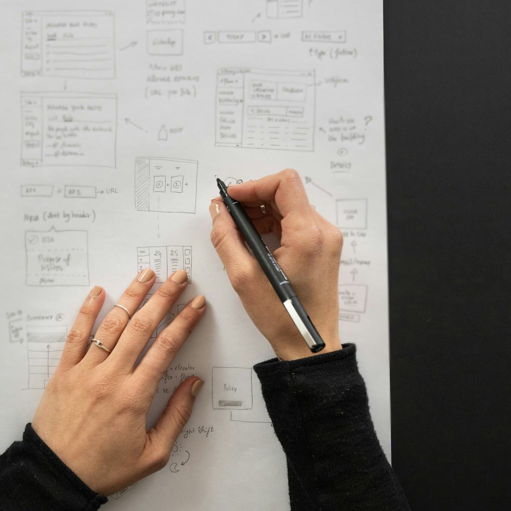 Photo of Myrian sketching wireframes on paper