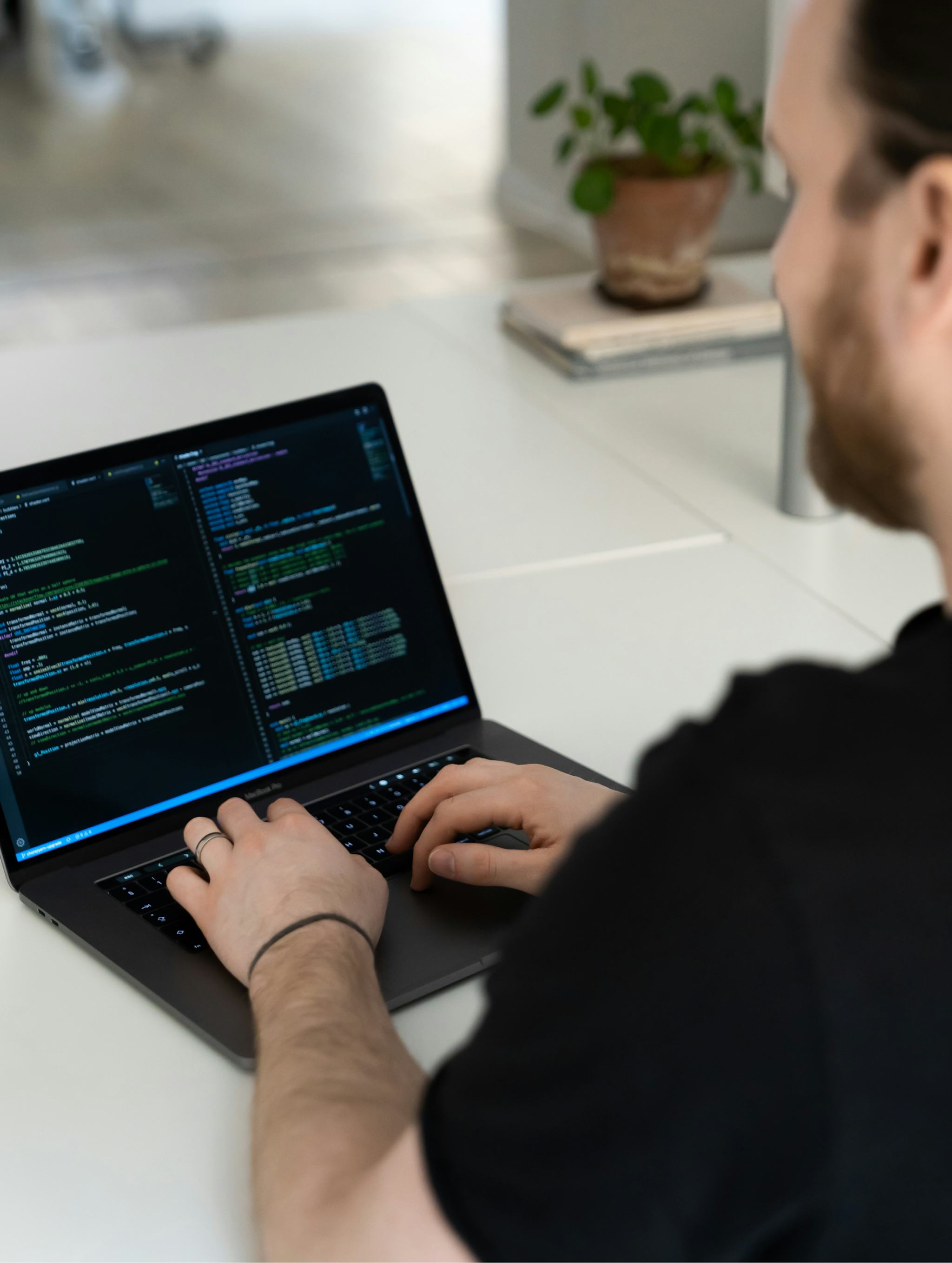 Photo of david coding on his laptop