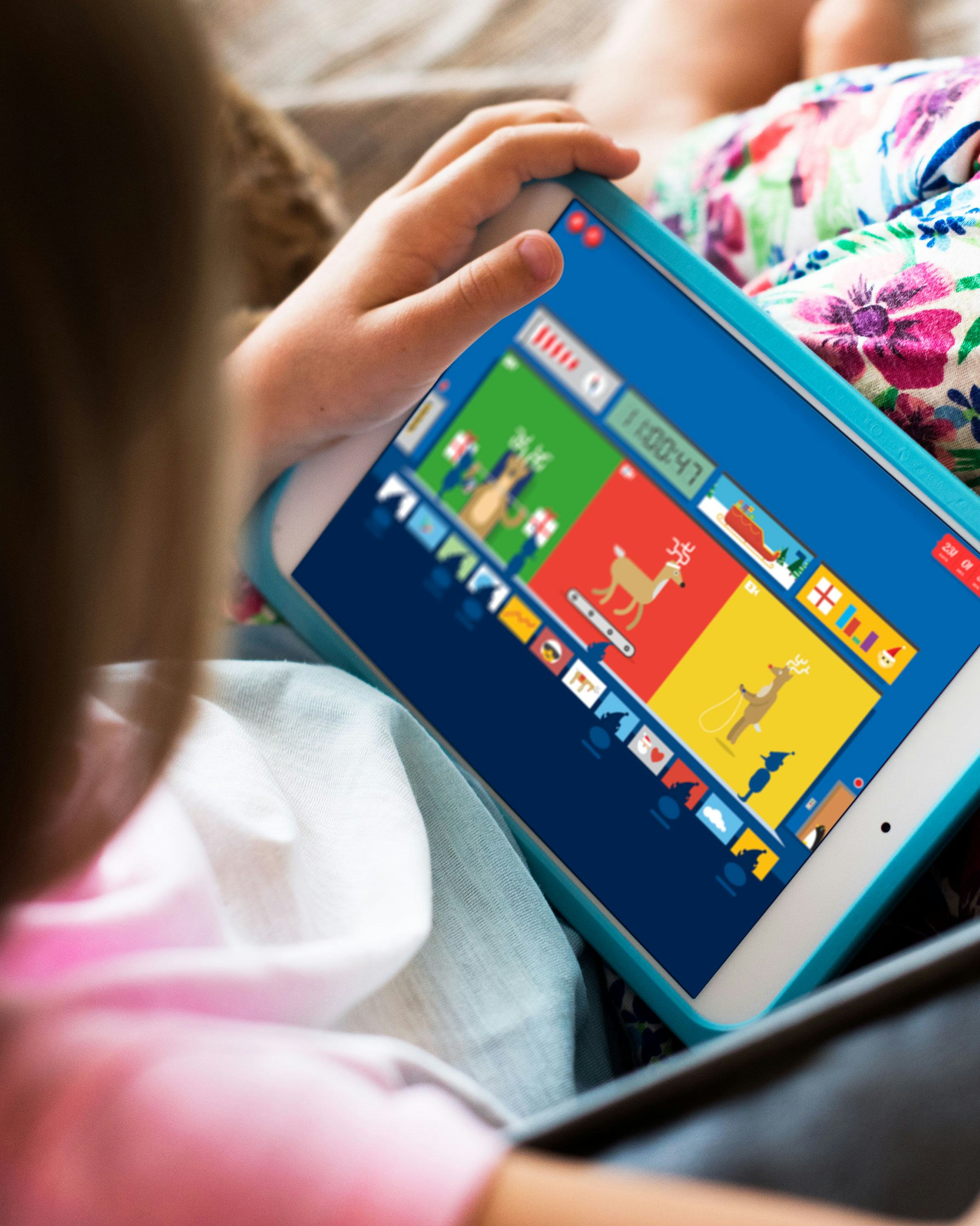 Girl playing Google Santa Tracker on a tablet