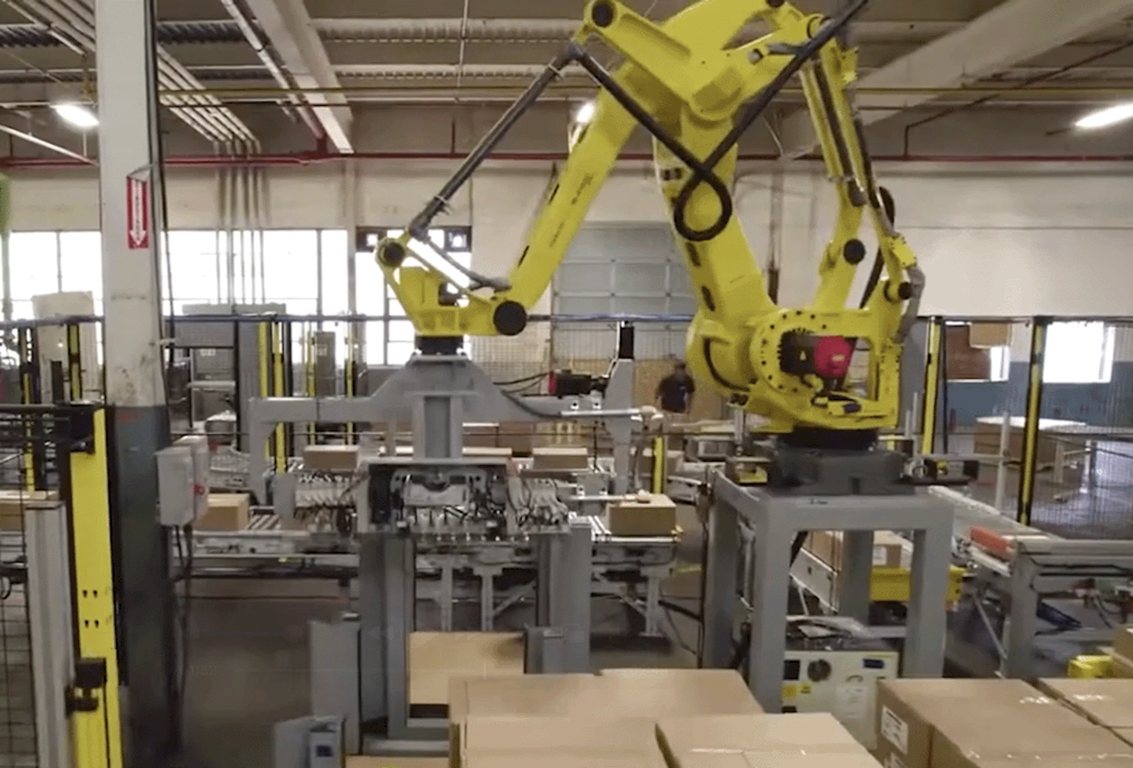 A yellow robot handling boxes
