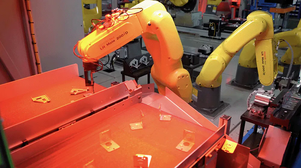 a yellow robot picking small fan components