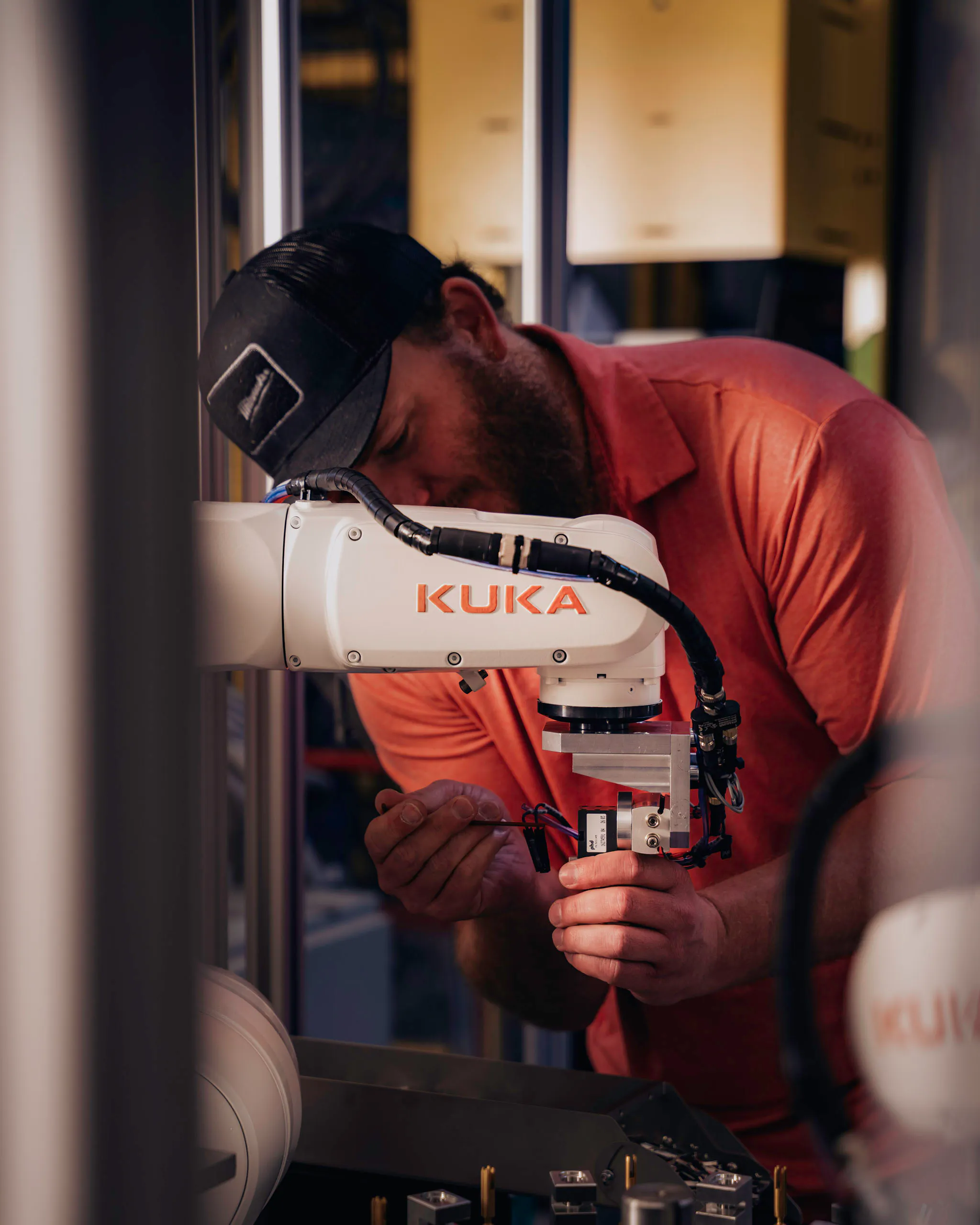 Acieta team member working on a KUKA robot
