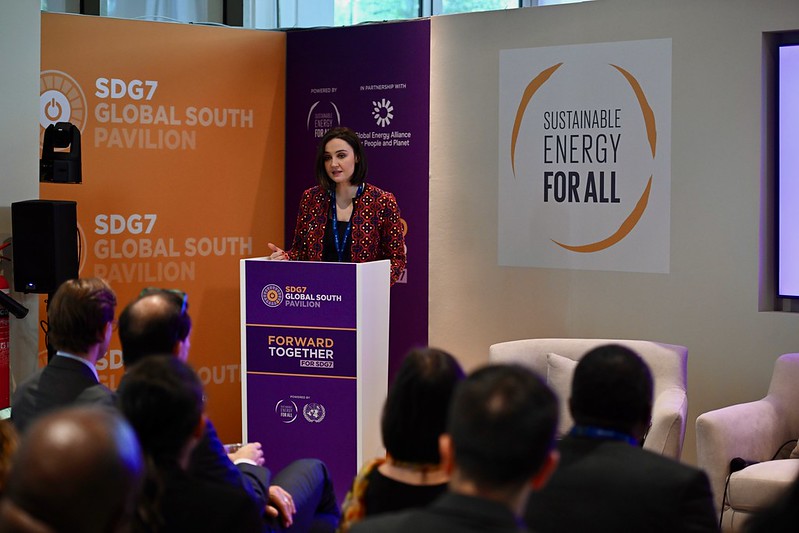 A woman speaking at a podium at a COP28 event 