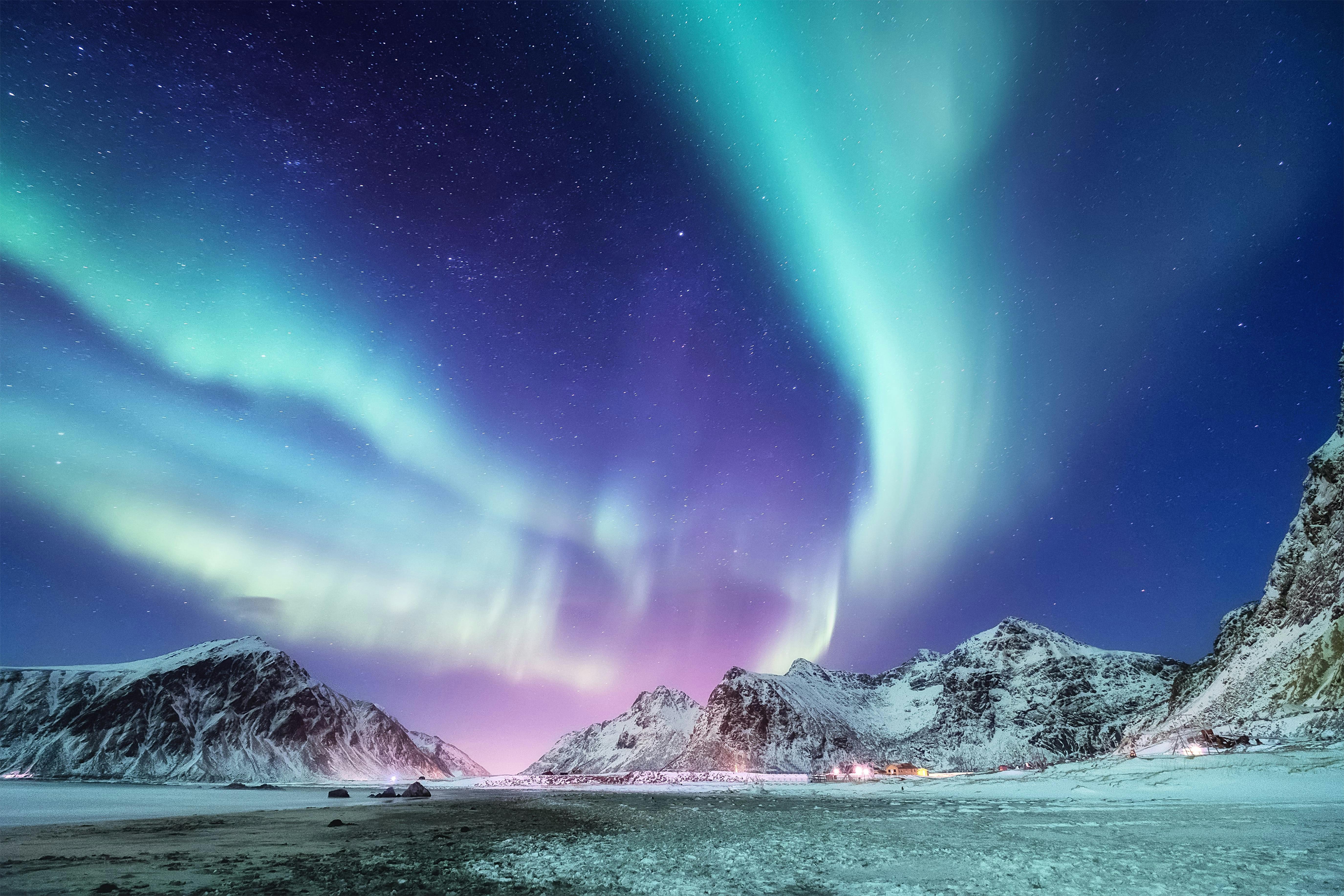 Northern lights over snowy mountains 