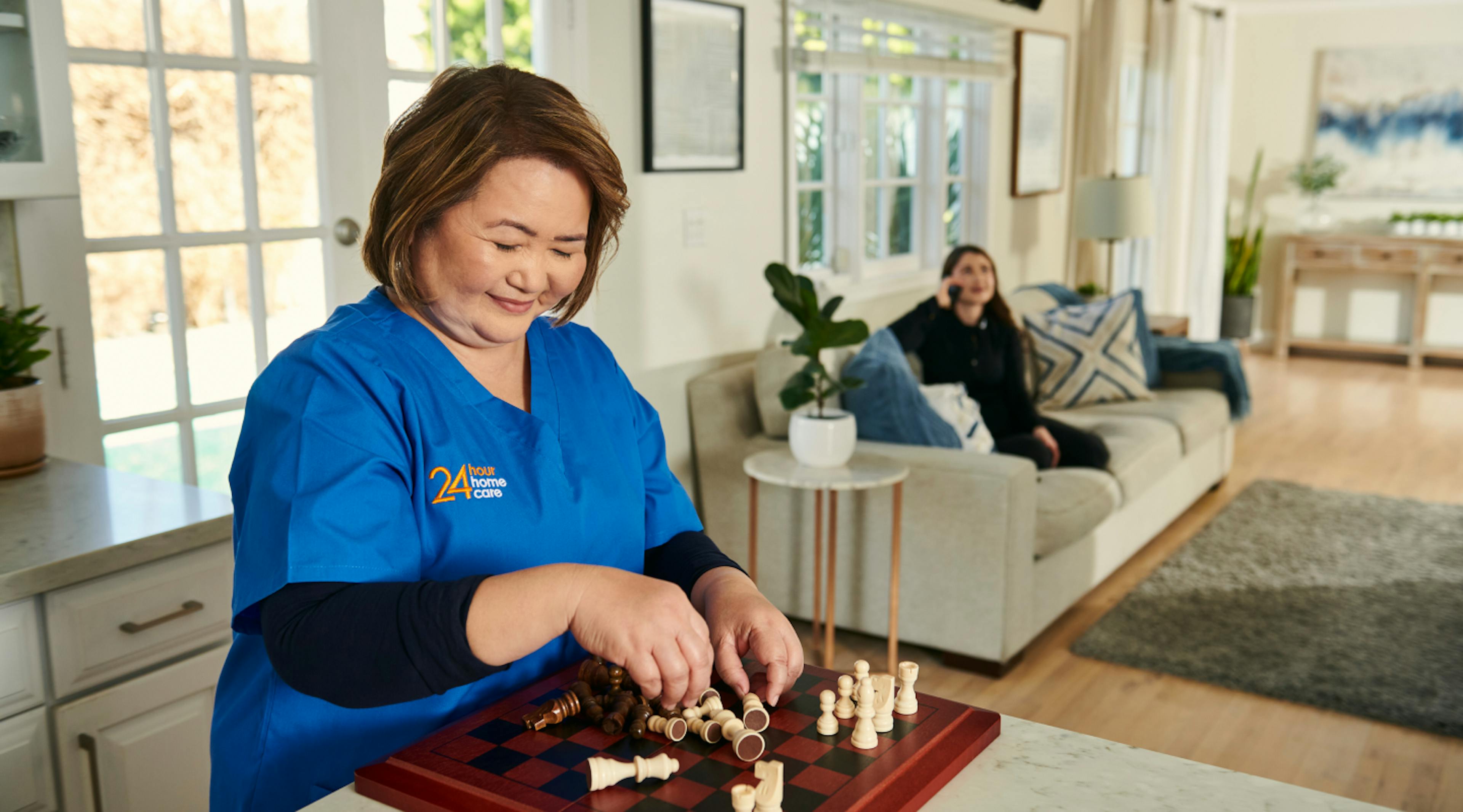 24 Hour caregiver picking up pieces on a chessboard