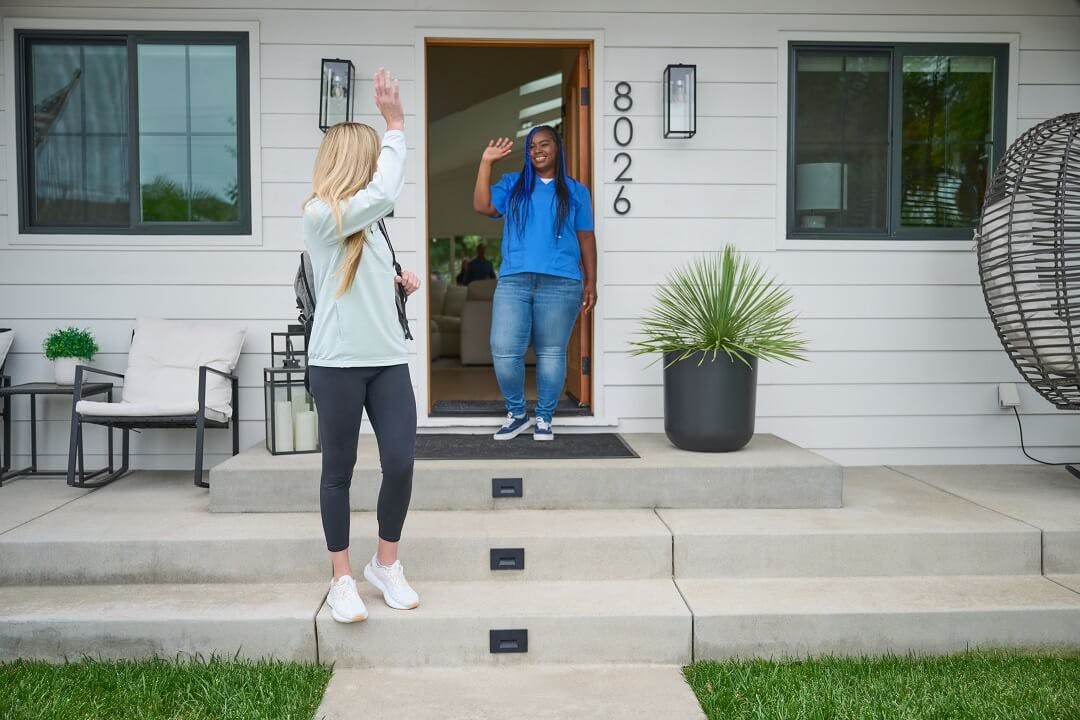 A 24 Hour Home Care caregiver waves goodbye to the primary family caregiver as they leave and the 24 Hour Home Care caregiver starts a respite shift.