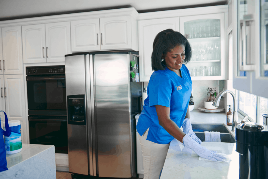 A caretaker cleaning a kitchen counter