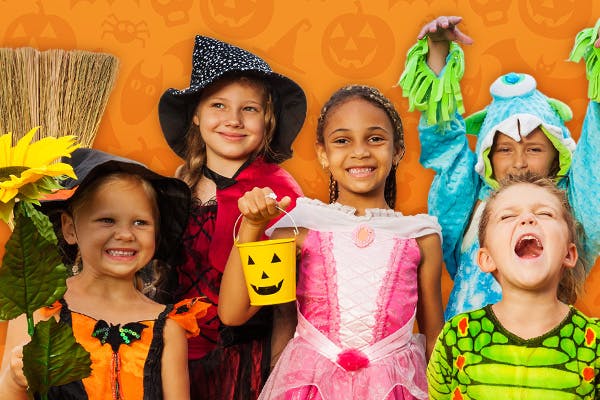 Five Treat-or-Treaters show off their costumes, including two witches, a princess, a dragon, and a monster costume.