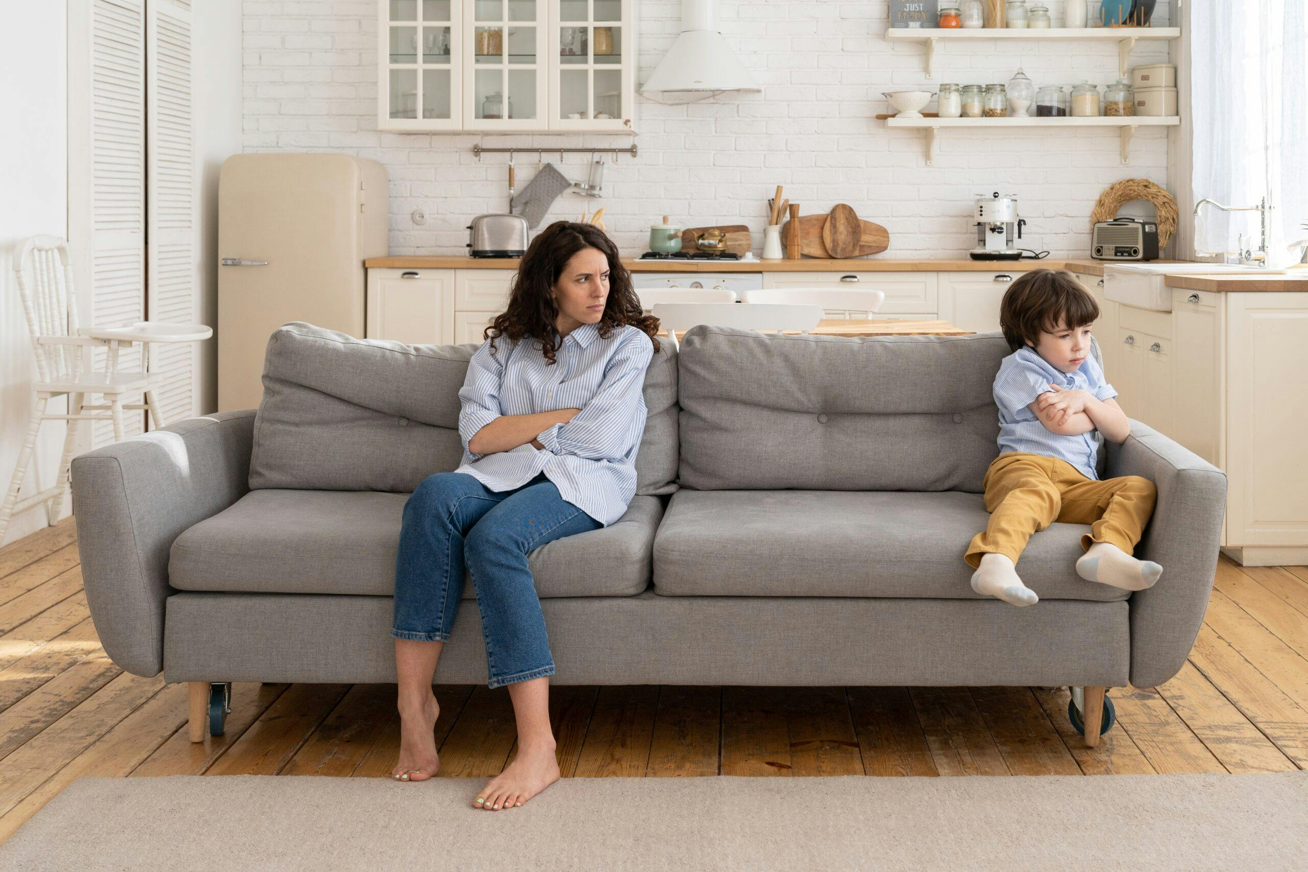 annoyed-mom-and-stubborn-child-sitting-on-couch-at-home-ignoring-each-other-posture-of-discontent-sad_t20_omGv9x