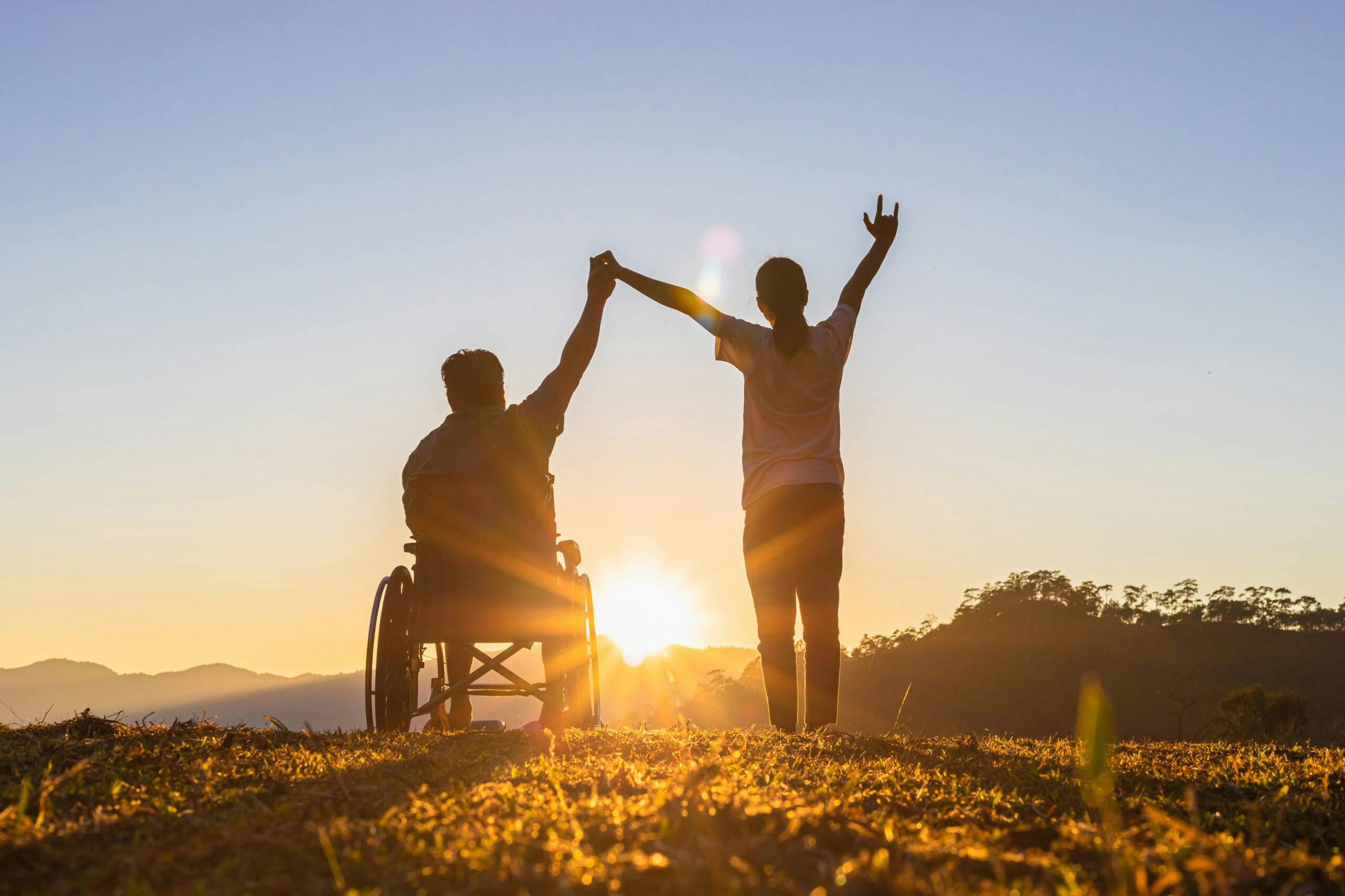 Disabled,Handicapped,Young,Man,In,Wheelchair,Raised,Hands,With,His