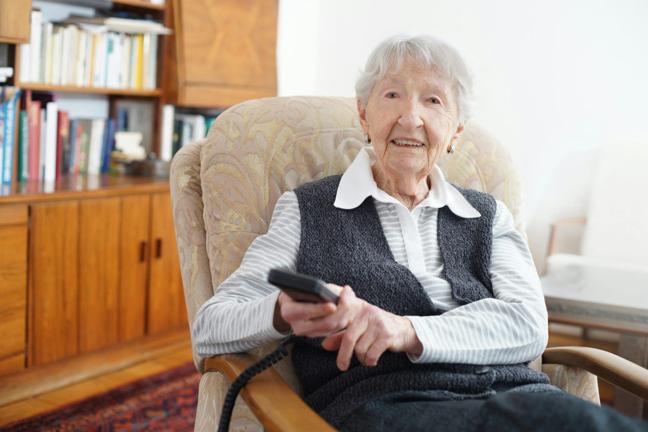 Senior lady at home in her TV chair