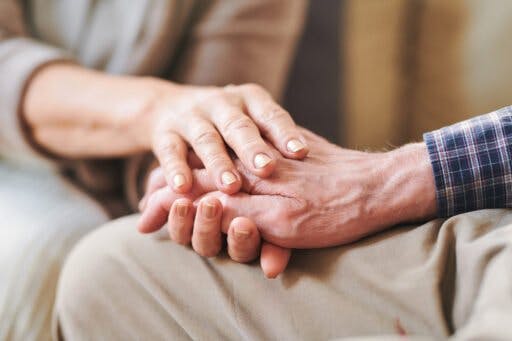 Caregiver holding Seniors hand