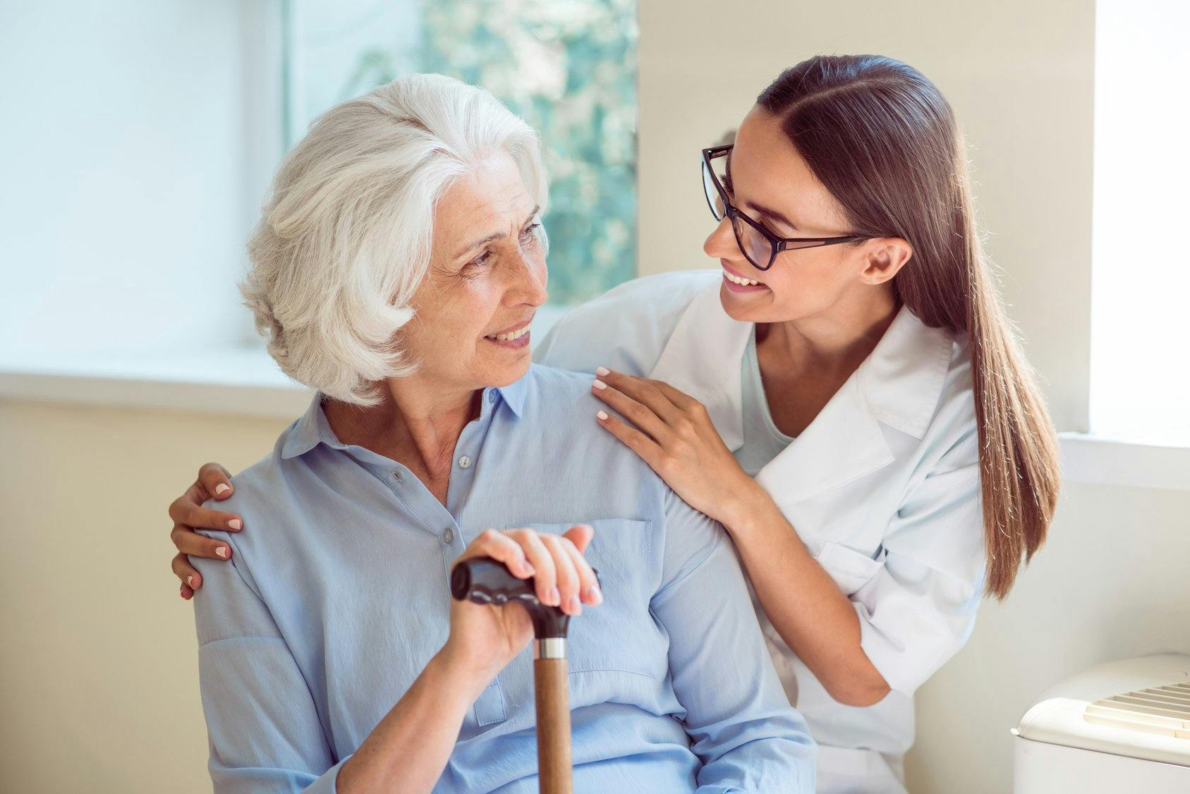 Young woman helping senior