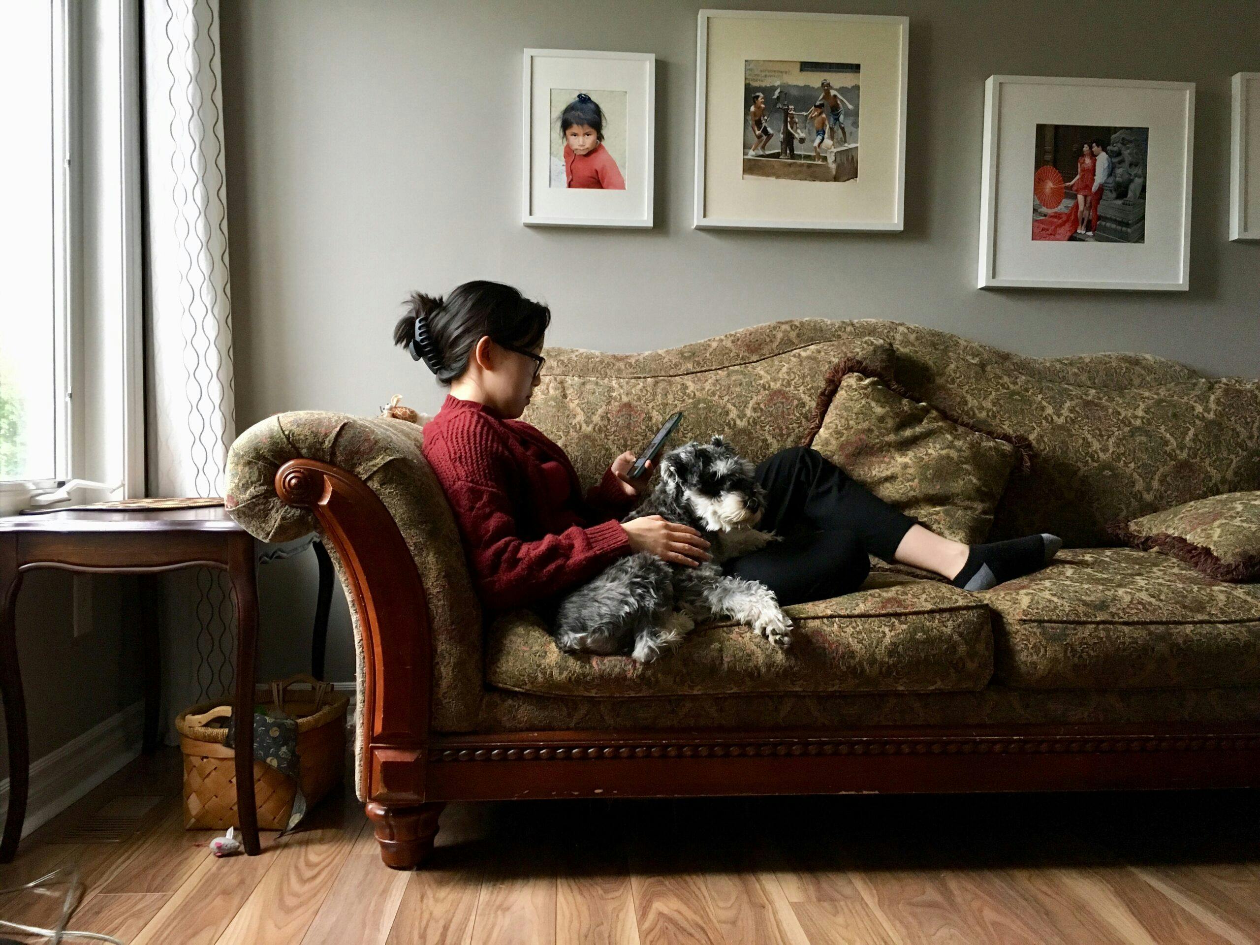 girl-is-resting-on-a-cozy-sofa-with-a-dog-nominated_t20_mogdBm