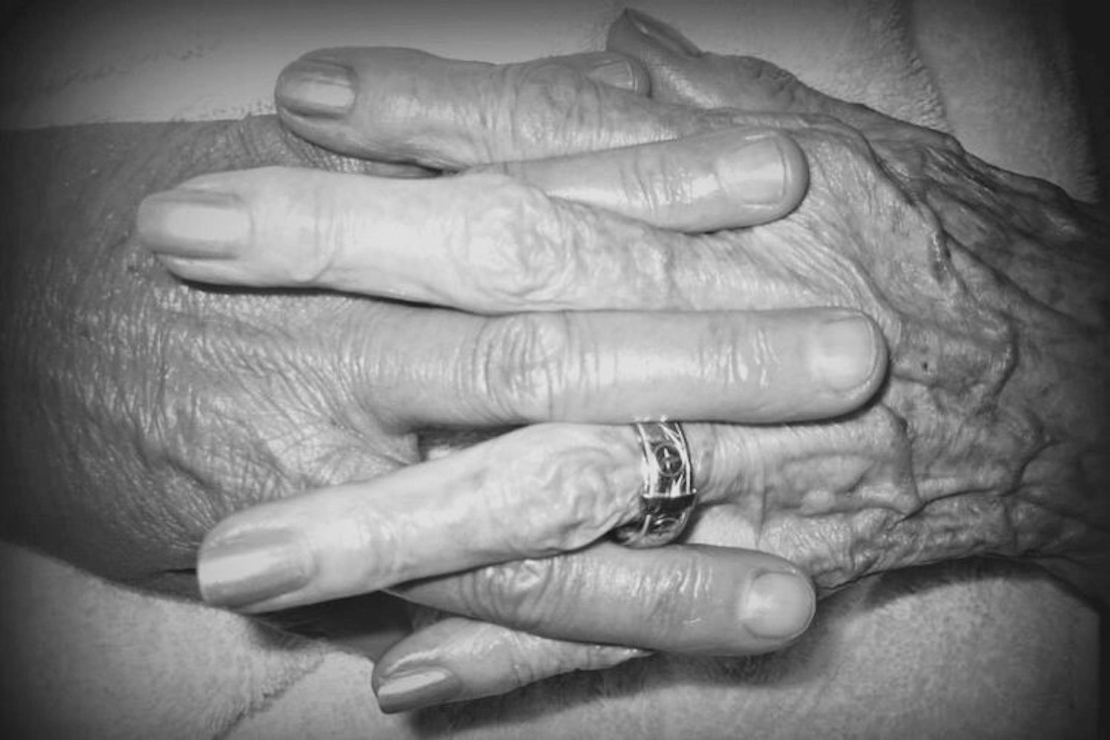 elderly-hands-folded-wearing-wedding-ring