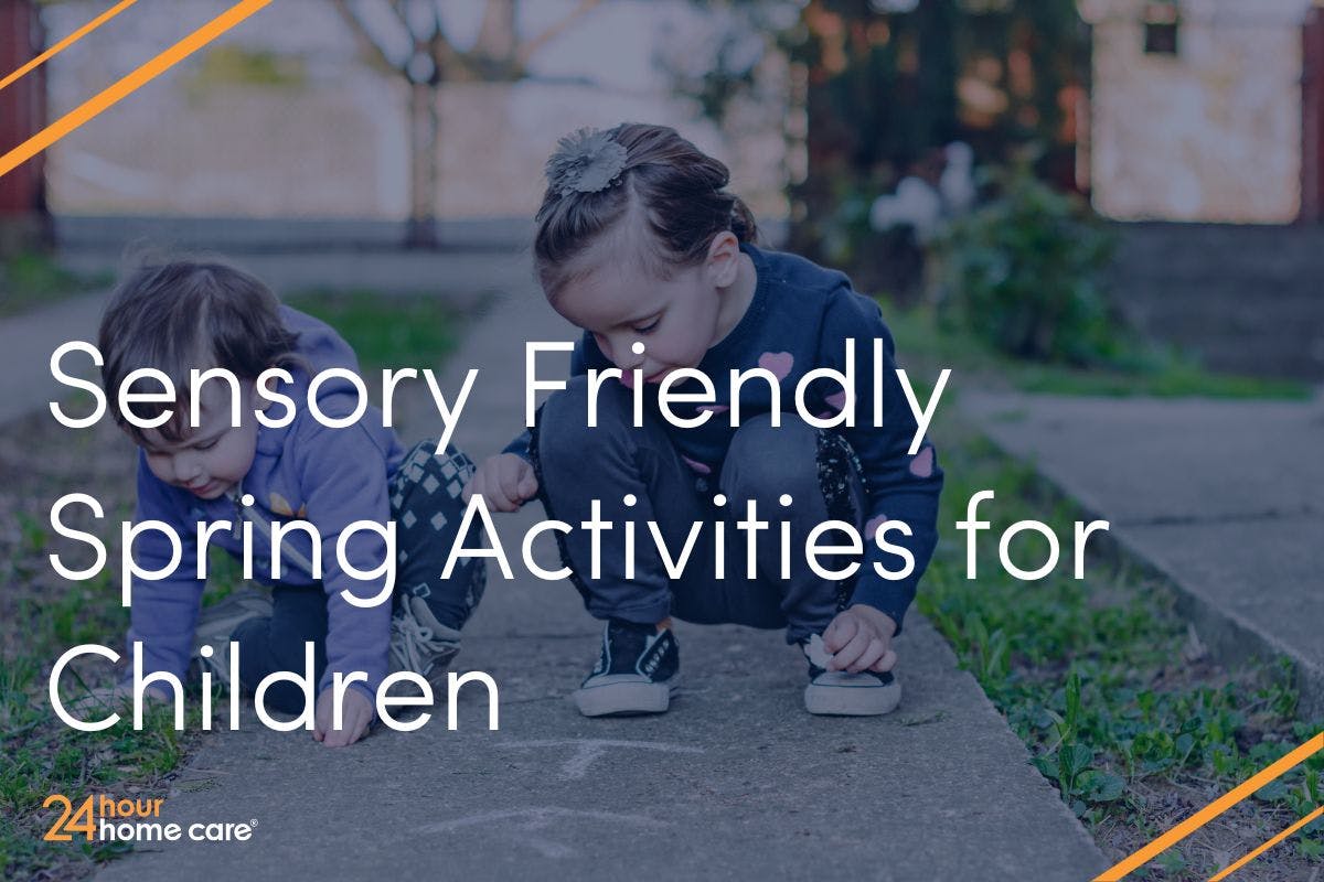Two children play outside with sidewalk chalk.