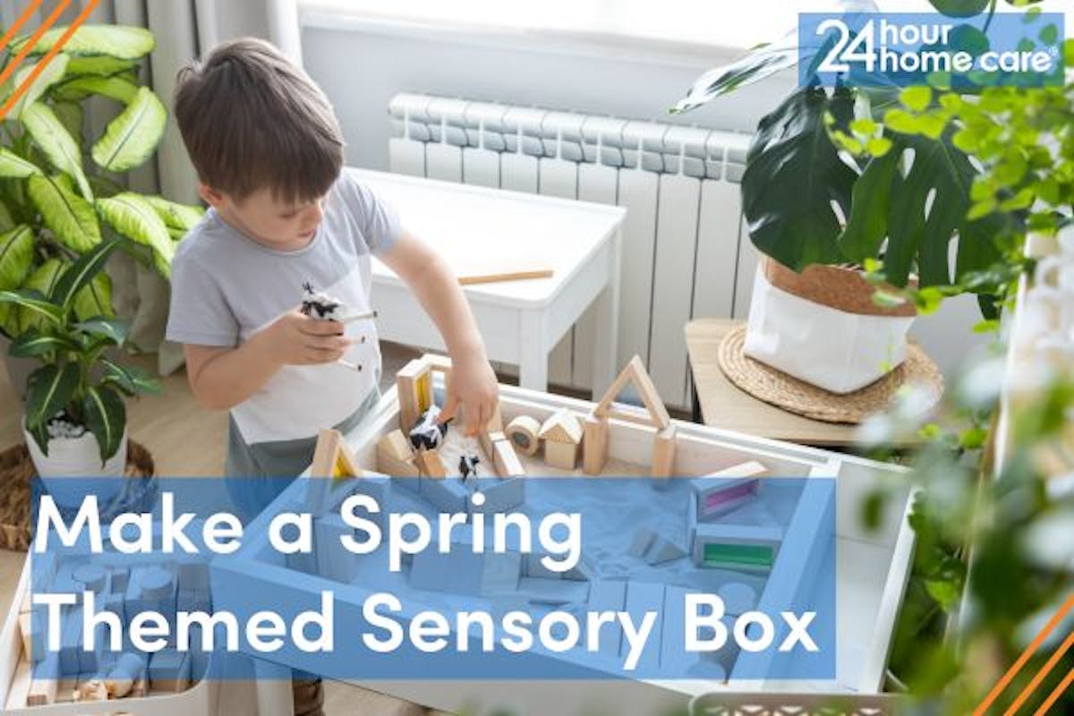 A young boy plays with a sensory box