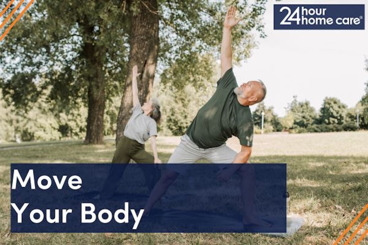 An older couple does yoga together outside.