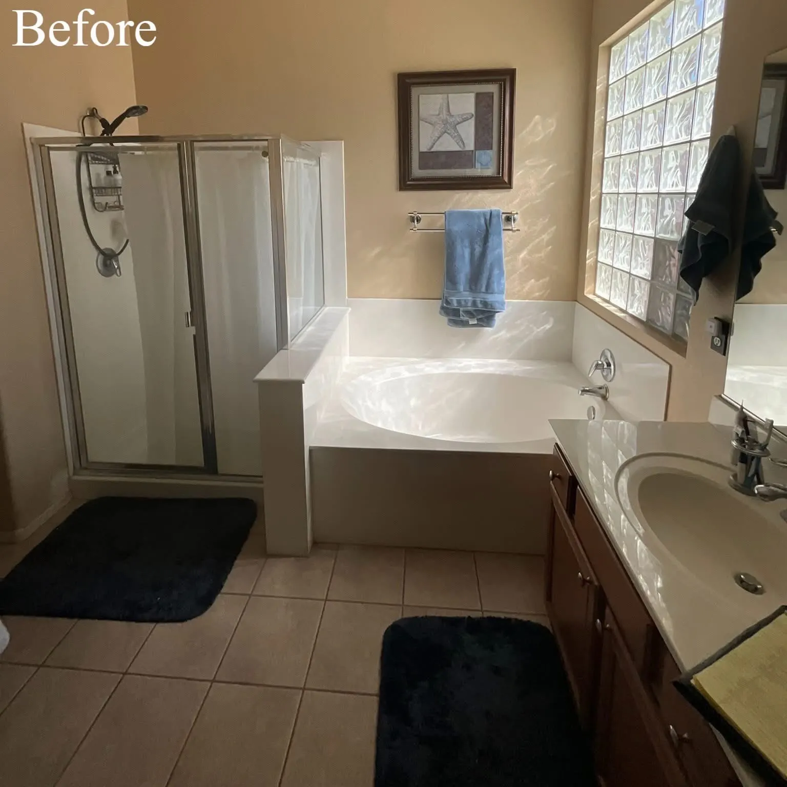 Bathroom before remodeling, with an enclosed shower, corner tub, glass-block window, and dark wood vanity.