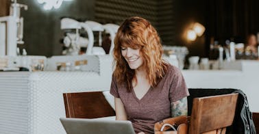 woman in cafe representing learning experience platforms