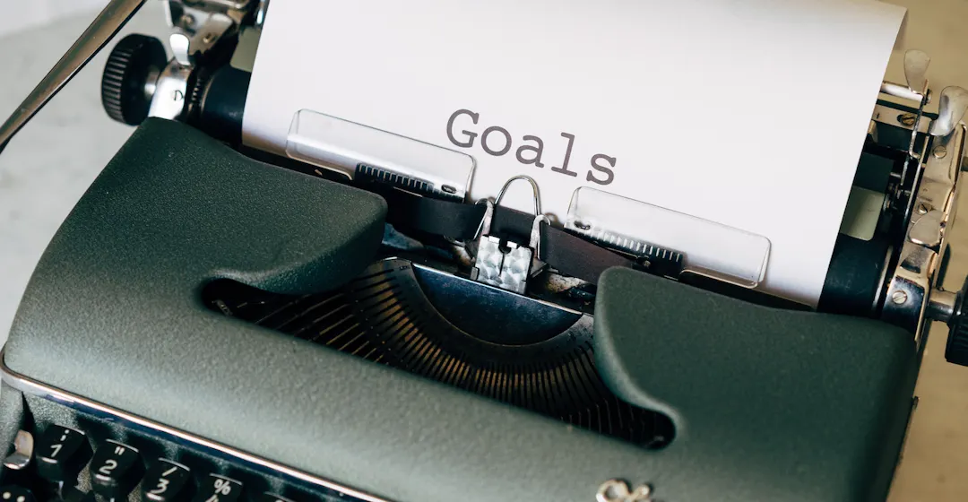 goals on typewriter representing employee development plan