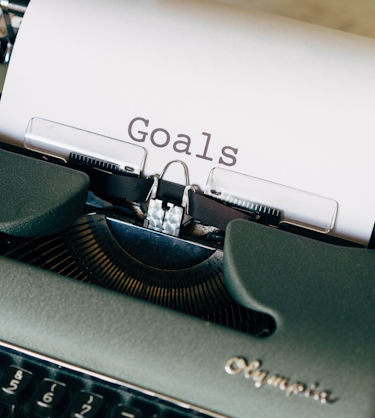 goals on typewriter representing employee development plan