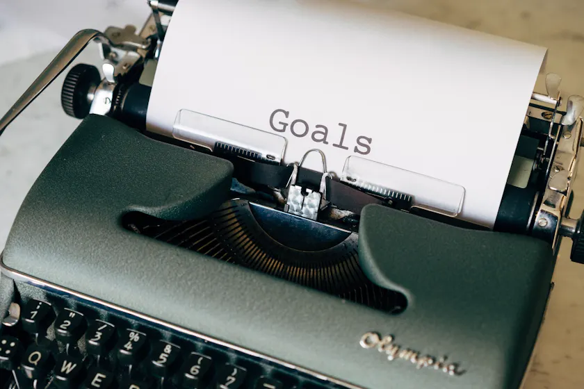 goals on typewriter representing employee development plan