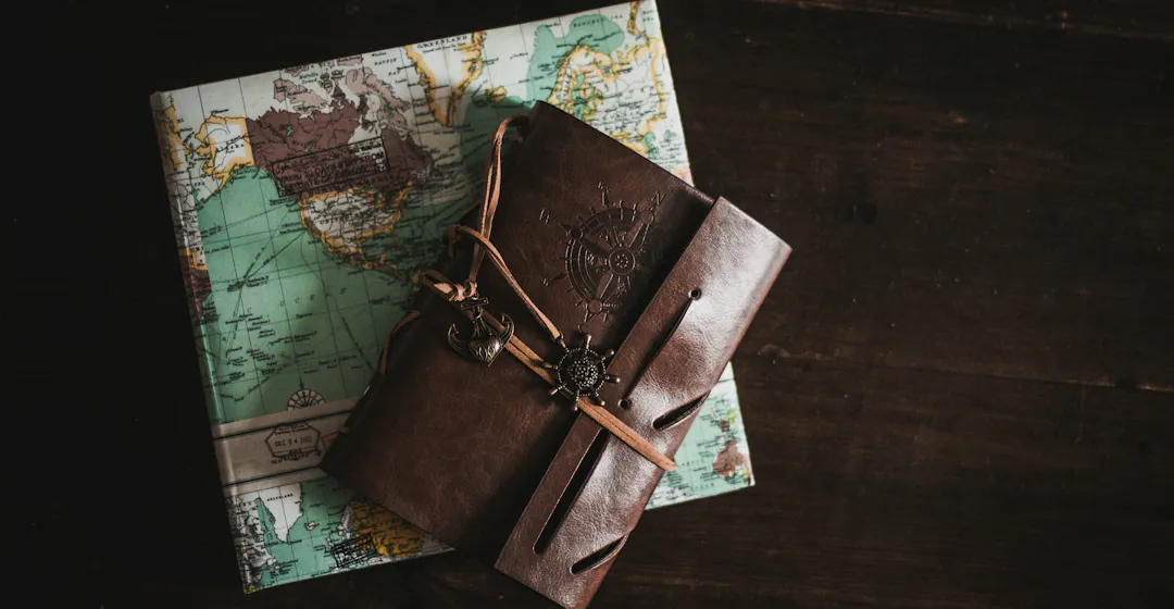A photo of a map and journal representing the onboarding process chart.