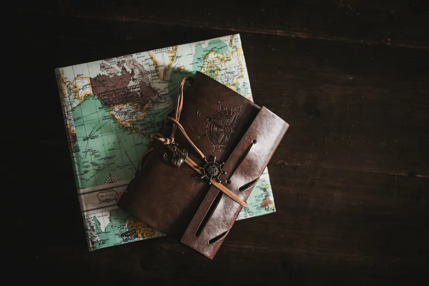 A photo of a map and journal representing the onboarding process chart.