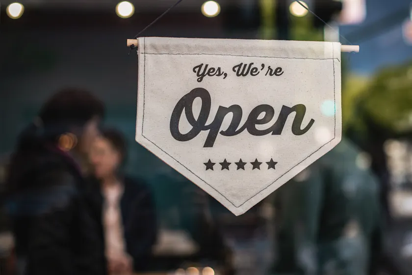 An open sign representing customer education