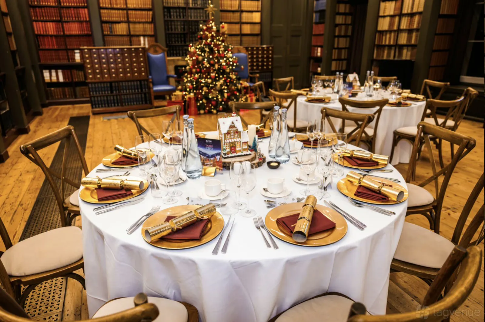 Dinner table set with gold place settings in the Lumley Library at The View