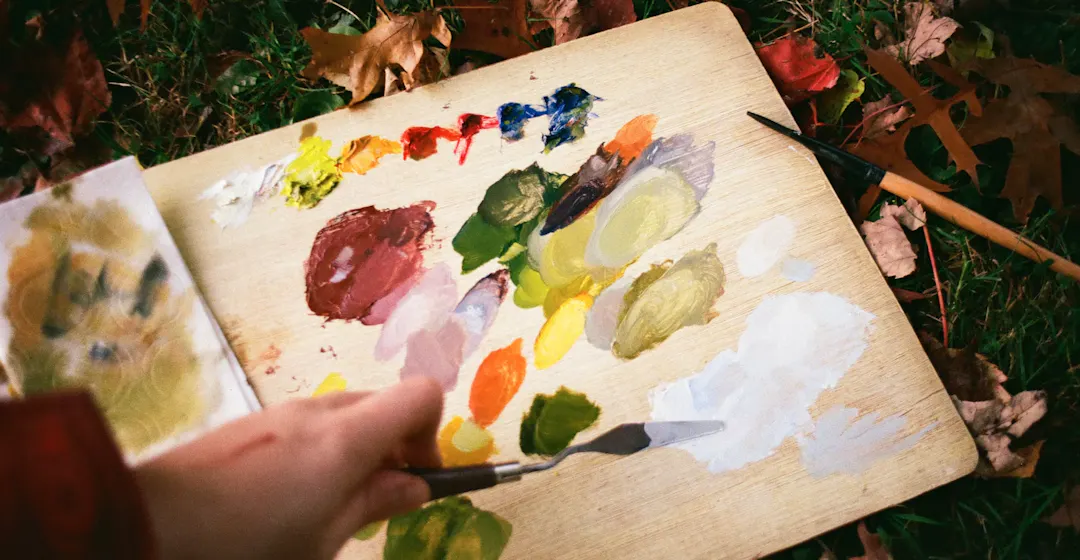 A person painting, representing the choice between TalentLMS and 360Learning