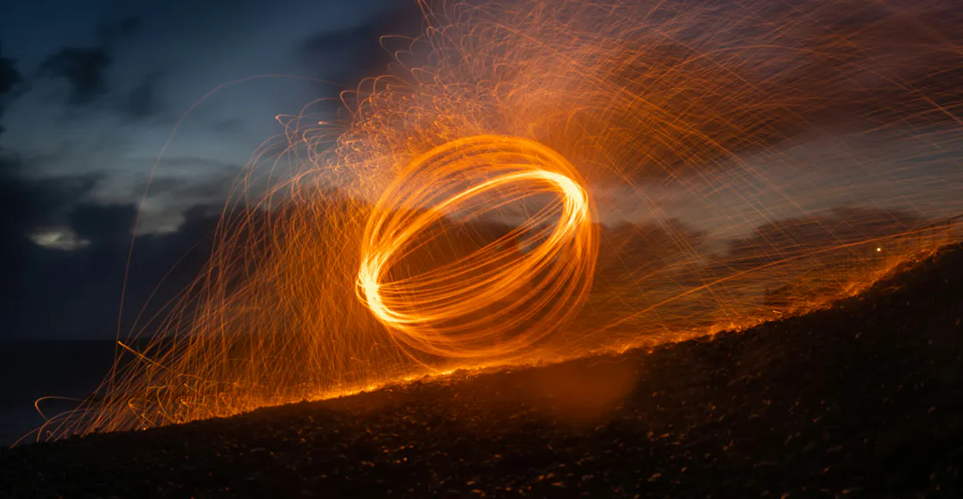 A time-lapse of a spinning sparkler at night representing surging skills development.